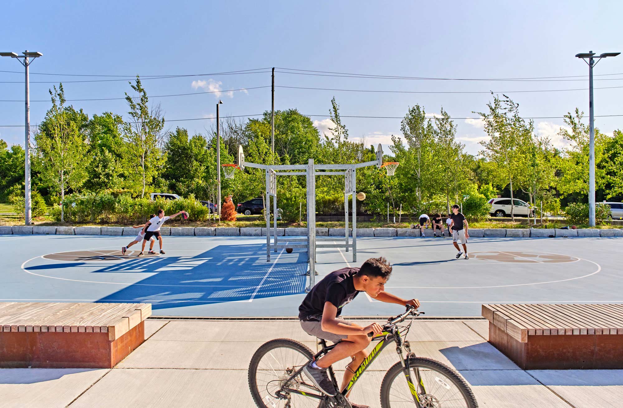 a person riding a bike on a basketball court.