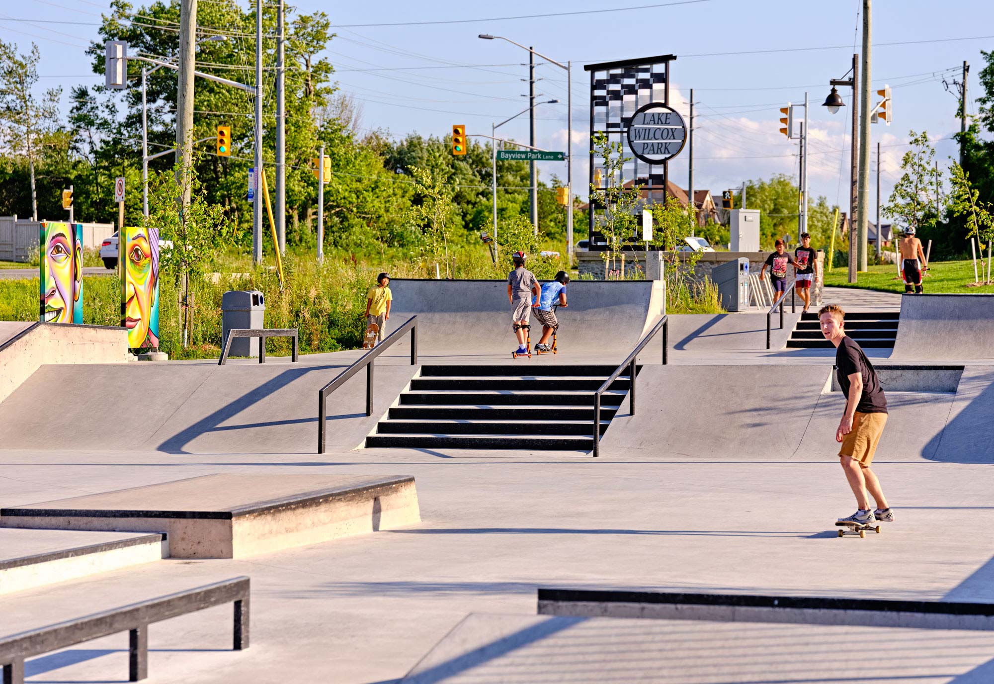 a group of people riding skateboards at a skate park.