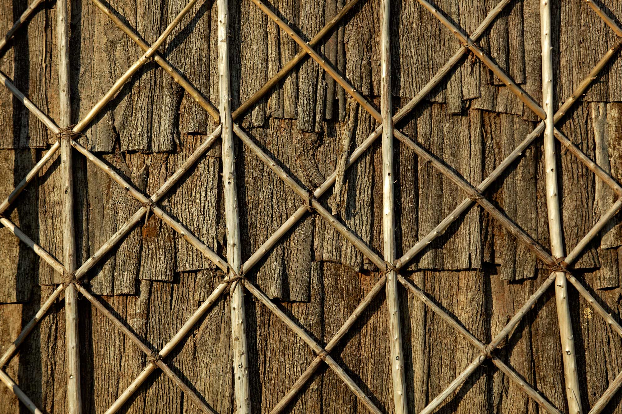 a close up of a wooden fence with metal bars.