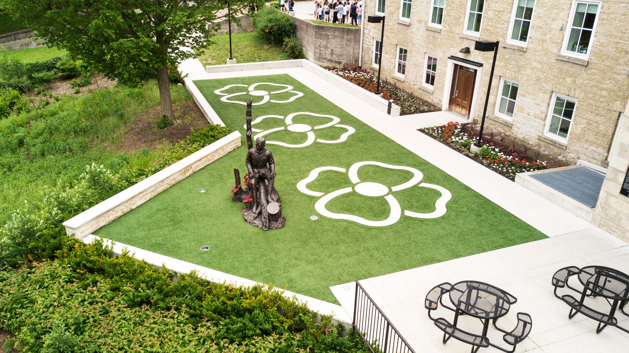 an aerial view of a lawn with a flower design on it.