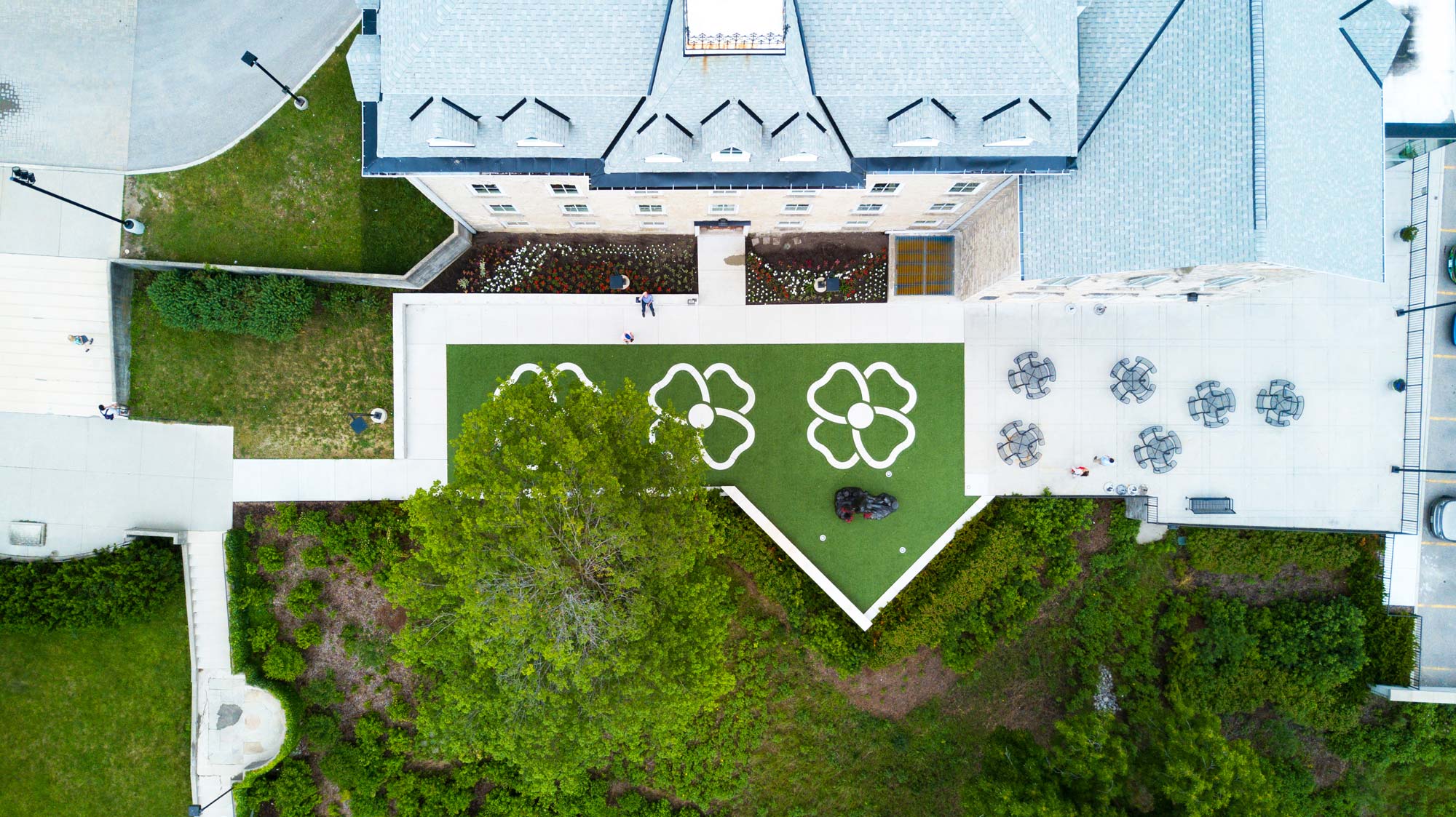 an aerial view of a house with a green roof.
